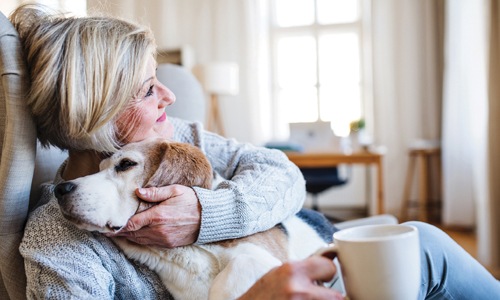 A woman relaxing at home with her dog