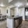 Model kitchen and dining room at AVIVA Fort Worth senior living community in Fort Worth, TX, featuring wood grain flooring.
